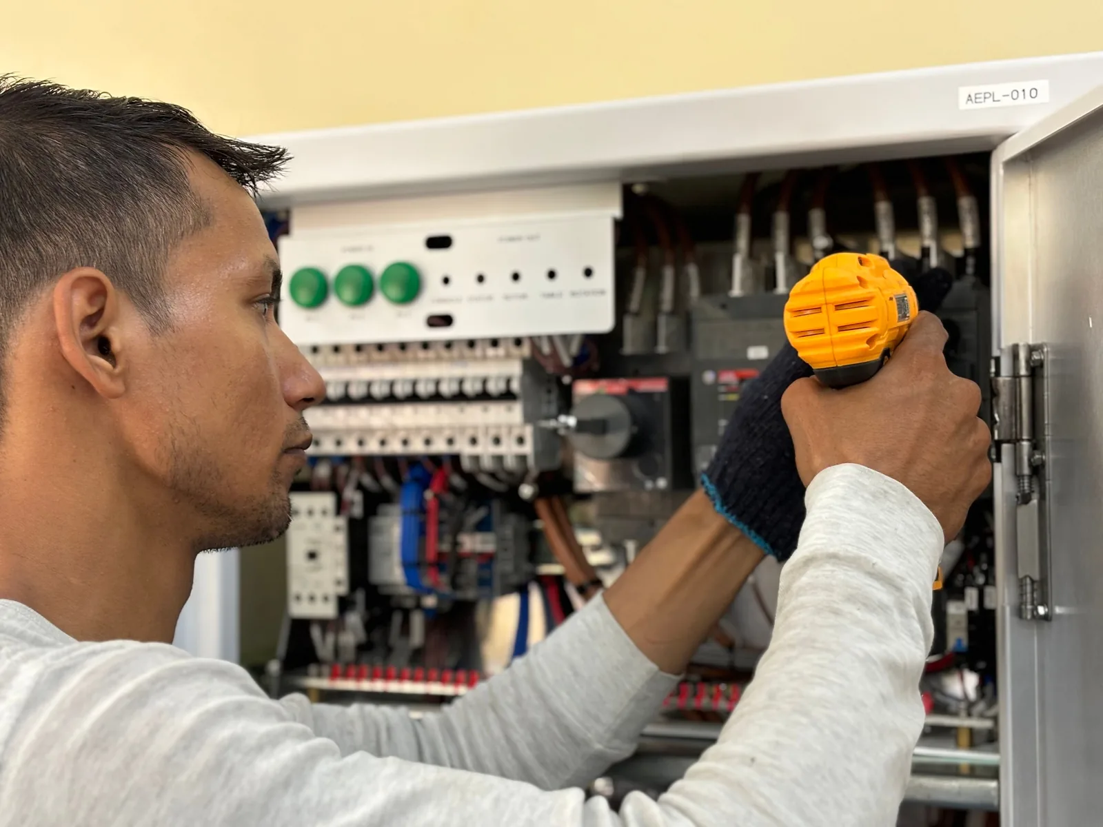 An electrician working on a commercial control panel, for panel upgrade in Vancouver