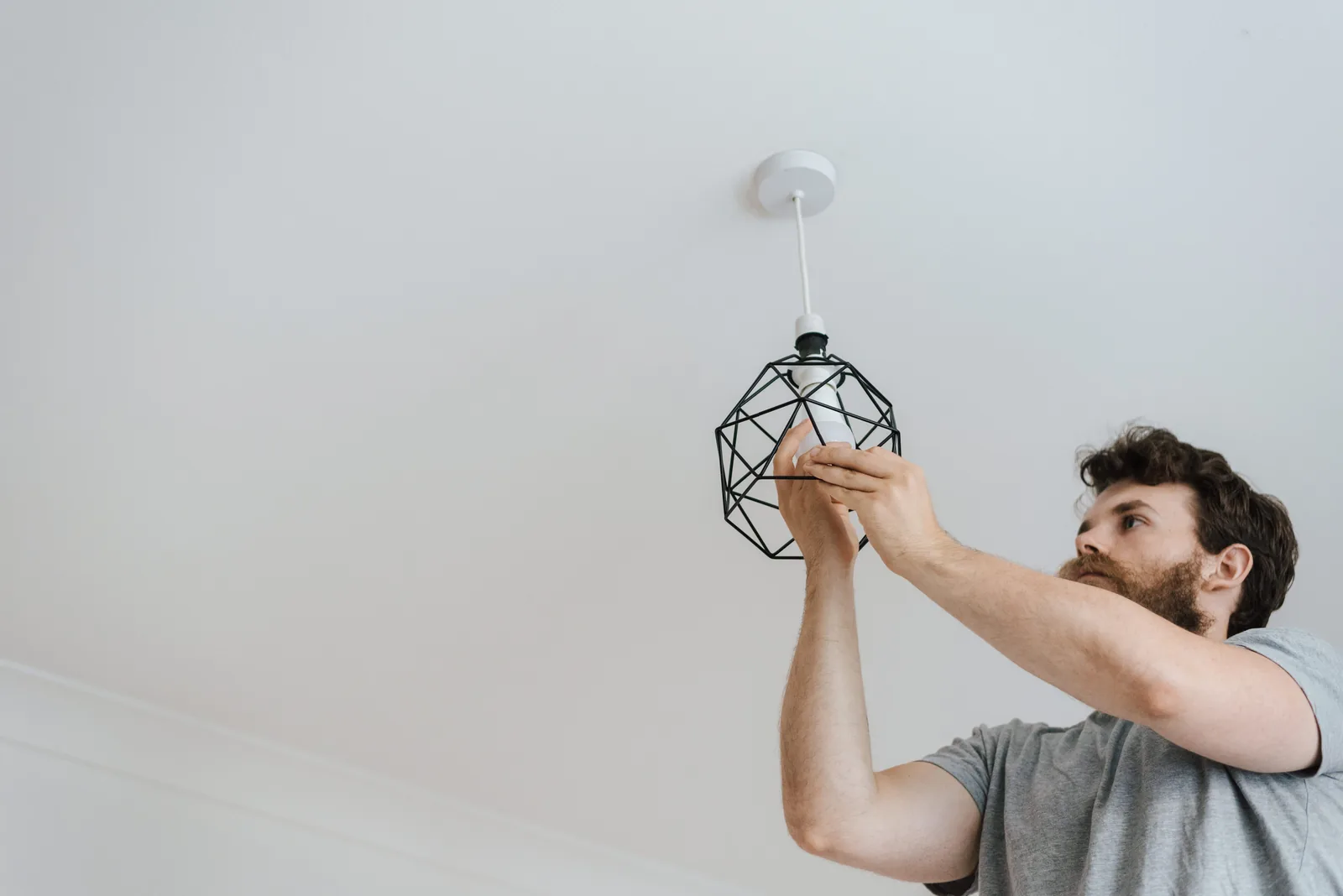 Fitting a lamp into a pendant fixture, for ev charger installation in Vancouver